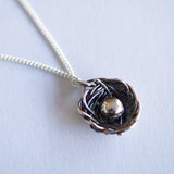 silver egg in nest necklace on chain