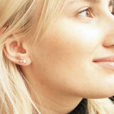 pretty girl wearing celestial stud earrings