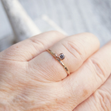 gold gemstone dangle ring on old ladies hand