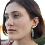 silver rectangle earrings on model Alex