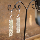 hammered monolith earrings on display