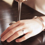 Wide band ring on finger