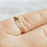 gold signet ring on finger