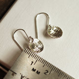 silver disc earrings with ruler for size