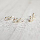 Silver infinity earrings with silver backings