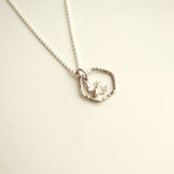 Sterling silver bee  necklace with a honeycomb shaped pendant.