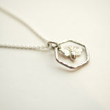 Silver honey bee necklace with a sterling silver hexagonal pendant.