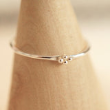 Sterling silver ring with three small beads.