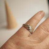 Silver croissant ring on a finger
